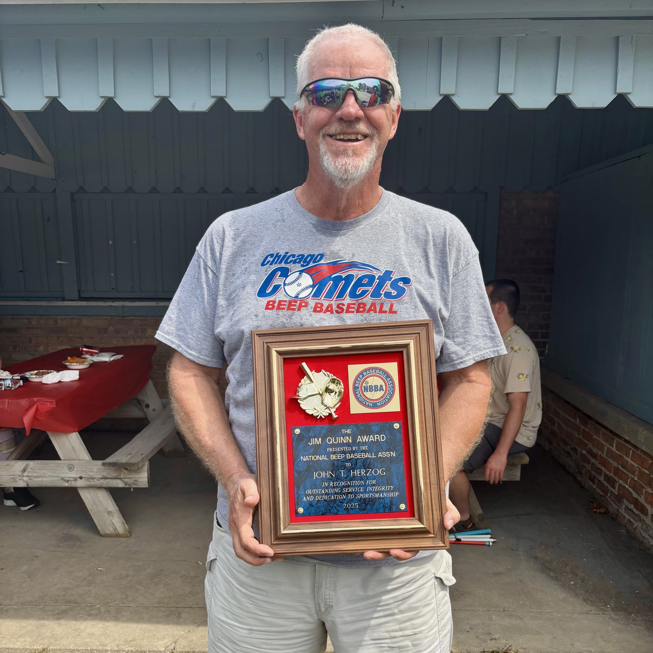 JT wearing a Chicago Comets shirt and holding his award
